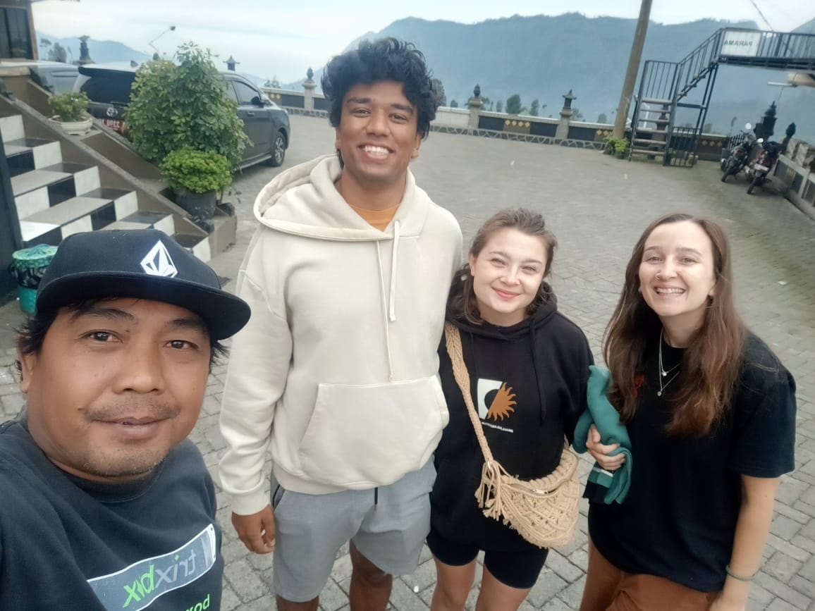 Scenic view of Kawah Ijen volcano at sunset with colorful sky and crater lake